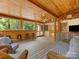 Relaxing outdoor patio with wood ceiling and comfortable seating at 5322 Bridgeview Dr, Iron Station, NC 28080