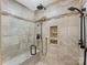 Tiled shower with multiple shower heads and a built-in tiled niche at 5322 Bridgeview Dr, Iron Station, NC 28080