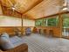 Cozy sunroom featuring wood walls, multiple windows, ceiling fans, and comfortable seating at 5322 Bridgeview Dr, Iron Station, NC 28080