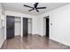 Bright bedroom features hardwood floors, fresh paint, large closet, and ceiling fan at 5442 Kinsale Ln, Charlotte, NC 28215
