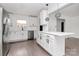 Modern eat-in kitchen with white cabinets, quartz countertops, stainless steel appliances, and pendant lighting at 5442 Kinsale Ln, Charlotte, NC 28215