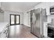 Bright eat-in kitchen boasts stainless steel appliances, white cabinets, and double glass doors to the deck at 5442 Kinsale Ln, Charlotte, NC 28215