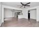 Open floor plan featuring a modern kitchen, hardwood floors, barn door, and a ceiling fan at 5442 Kinsale Ln, Charlotte, NC 28215