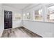 Bright sunroom with light wood vinyl flooring, fresh paint, and lots of natural light at 5442 Kinsale Ln, Charlotte, NC 28215