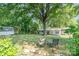 Expansive backyard with seating area, shed, and mature trees creating a serene setting at 5742 Murrayhill Rd, Charlotte, NC 28210