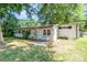 Spacious backyard with mature trees, lush grass, and a seating area at 5742 Murrayhill Rd, Charlotte, NC 28210