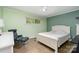 Bright bedroom with hardwood floors, accent wall, and comfortable furniture at 5742 Murrayhill Rd, Charlotte, NC 28210