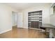 Bright bedroom with hardwood floors, built in closet, and a gray desk near the window at 5742 Murrayhill Rd, Charlotte, NC 28210