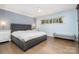 Comfortable bedroom with a large bed, hardwood floors, and natural light at 5742 Murrayhill Rd, Charlotte, NC 28210