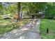Charming single-story home with mature trees, a long driveway, and a carport at 5742 Murrayhill Rd, Charlotte, NC 28210