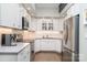 Modern kitchen with stainless steel appliances, white cabinetry and subway tile backsplash at 5742 Murrayhill Rd, Charlotte, NC 28210