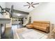 Spacious living room with white brick walls, cozy leather sofa and large windows at 5742 Murrayhill Rd, Charlotte, NC 28210