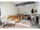 Spacious living room with white brick walls, cozy leather sofa and large windows at 5742 Murrayhill Rd, Charlotte, NC 28210