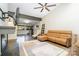 Spacious living room with white brick walls, cozy leather sofa and large windows at 5742 Murrayhill Rd, Charlotte, NC 28210