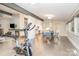 Bright open living space featuring hardwood floors, dining area, kitchen and exercise equipment at 5742 Murrayhill Rd, Charlotte, NC 28210