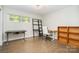 Home office with desk, bookshelf and hardwood floors at 5742 Murrayhill Rd, Charlotte, NC 28210