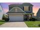 Charming two-story home featuring a stone facade and attached garage with a well-manicured lawn at 6156 Kilchurn Dr, Fort Mill, SC 29707