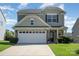 Charming two-story home featuring a stone facade and attached garage with a well-manicured lawn at 6156 Kilchurn Dr, Fort Mill, SC 29707