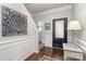 Welcoming foyer featuring beautiful wainscoting, modern lighting, and a stylish front door with decorative glass at 6156 Kilchurn Dr, Fort Mill, SC 29707