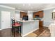Kitchen island with granite countertops, pendant lighting, and ample seating in a modern layout at 6156 Kilchurn Dr, Fort Mill, SC 29707