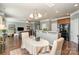 Open-concept design with hardwood floors, connecting the dining area, living room, and kitchen seamlessly at 6156 Kilchurn Dr, Fort Mill, SC 29707