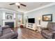 Comfortable living room with a fireplace, hardwood flooring, and a view of the front yard at 6156 Kilchurn Dr, Fort Mill, SC 29707