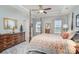 Elegant main bedroom with four-poster bed, tray ceiling, and plenty of natural light from the windows at 6156 Kilchurn Dr, Fort Mill, SC 29707
