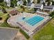 Aerial view of community pool with lounge chairs, umbrellas, and a clubhouse at 6156 Kilchurn Dr, Fort Mill, SC 29707