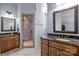 Bathroom features a granite-topped vanity, framed mirrors, and tiled shower at 617 Beauhaven Ln, Waxhaw, NC 28173