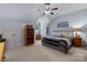 Cozy bedroom features carpet flooring, a ceiling fan, and a unique design at 617 Beauhaven Ln, Waxhaw, NC 28173