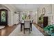 Elegant dining room with hardwood floors, wainscoting, large windows, and sophisticated decor at 617 Beauhaven Ln, Waxhaw, NC 28173