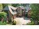 Beautiful brick and stone home featuring a circular driveway, professional landscaping, and a three car garage at 617 Beauhaven Ln, Waxhaw, NC 28173