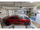 Spacious garage with epoxy floors and ample storage space, featuring a red sports car at 617 Beauhaven Ln, Waxhaw, NC 28173