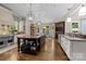 Gourmet kitchen with large island, stainless steel appliances, hardwood floors, and custom cabinetry at 617 Beauhaven Ln, Waxhaw, NC 28173