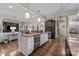 Open concept kitchen with stainless steel appliances, wine cooler, and views to the living area at 617 Beauhaven Ln, Waxhaw, NC 28173