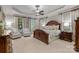 Luxurious main bedroom suite with tray ceilings, sitting area, and custom window treatments at 617 Beauhaven Ln, Waxhaw, NC 28173