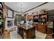 Executive office featuring a fireplace, custom bookshelves, and a large desk at 617 Beauhaven Ln, Waxhaw, NC 28173