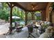 Relaxing covered patio area with comfortable seating and a view of the sparkling pool at 617 Beauhaven Ln, Waxhaw, NC 28173
