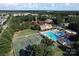 Aerial view of the community amenities including a pool, tennis courts, and a central clock tower at 7007 Creft Cir, Indian Trail, NC 28079