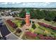 Aerial view of a brick clock tower surrounded by lush landscaping and homes at 7007 Creft Cir, Indian Trail, NC 28079