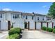 Townhouse back exterior with white fence and lush landscaping on a sunny day at 7007 Creft Cir, Indian Trail, NC 28079