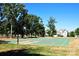 Outdoor basketball court with green surface, surrounded by trees and residential homes at 7007 Creft Cir, Indian Trail, NC 28079