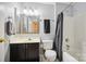 Bathroom with a vanity, toilet, and shower with a gray shower curtain at 7007 Creft Cir, Indian Trail, NC 28079