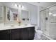 Bathroom featuring double sinks, modern fixtures, and a glass-enclosed shower at 7007 Creft Cir, Indian Trail, NC 28079
