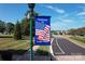 Welcome to Lake Park banner near street with landscaped sidewalks, flags, and homes at 7007 Creft Cir, Indian Trail, NC 28079