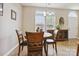 Bright dining area with a round table, wood chairs, and natural light from the window at 7007 Creft Cir, Indian Trail, NC 28079