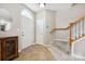 Inviting foyer with tile flooring, a staircase with wooden banister, and a front door with arched window at 7007 Creft Cir, Indian Trail, NC 28079