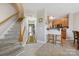 Open-concept hallway adjacent to the kitchen with wood flooring and staircase leading to the upper level at 7007 Creft Cir, Indian Trail, NC 28079