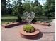 Outdoor heart sculpture surrounded by brickwork and landscaping in a community green space at 7007 Creft Cir, Indian Trail, NC 28079