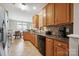 Traditional kitchen featuring granite countertops, tile backsplash, and wood cabinets overlooking breakfast area at 7007 Creft Cir, Indian Trail, NC 28079